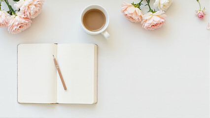 Flat lay of an open notebook, pen, coffee, and fresh flowers on a bright white table