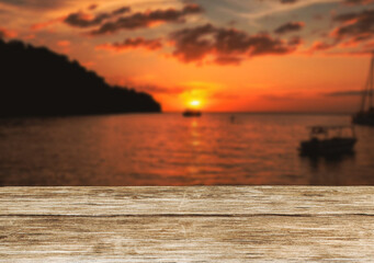 Wooden table top on the beach or sea.Party on the beach  sunset time concept.For montage product...