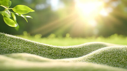 Soft green blanket on grass in sunny park.