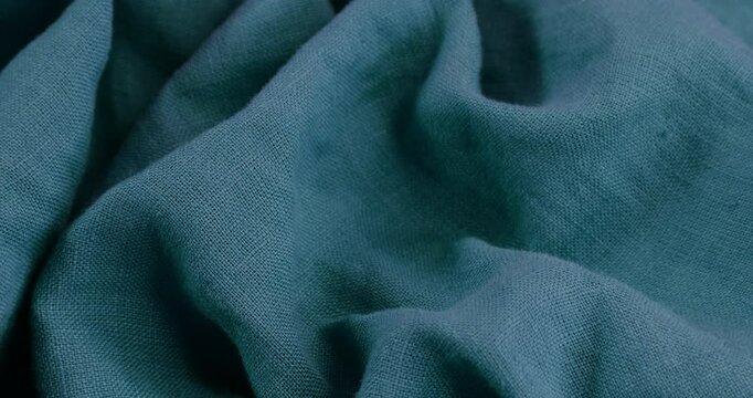 Turquoise fabric background. Turquoise cloth waves background texture. Turquoise fabric cloth textile material.