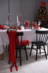 Christmas celebration. Festive table setting with dishware, glasses and decor