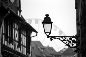 closeup of retro street lamp in the medieval street on big wheel background