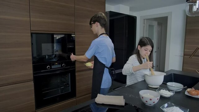 Teenage siblings baking cake together, brother operating oven while sister mixing ingredients in kitchen bowl, sharing culinary moments of family bonding and learning cooking skills