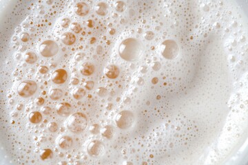 Close-Up View of Creamy Foam with Bubbles on Top of a Refreshing Beverage