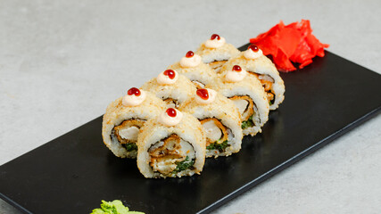 Sushi rolls on black tray