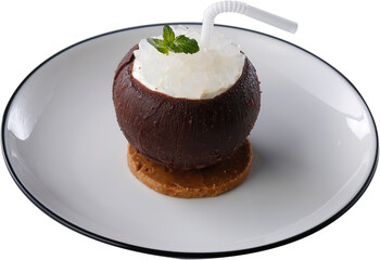 A coconut-inspired dessert featuring a chocolate shell filled with creamy layers and topped with translucent jelly cubes, a mint garnish, and a straw, elegantly placed on a crunchy cookie base.