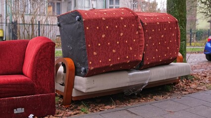 Old Unwanted Furniture Couch Dumped on Sidewalk on Bulk Garbage Collection Day for Curbside Pickup...
