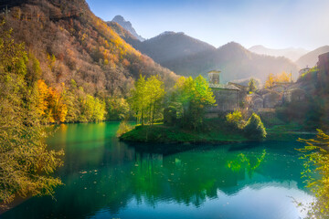 Isola Santa medieval village and lake in autumn foliage. Garfagnana, Tuscany, Italy.