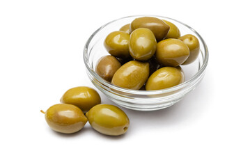 green olives in a glass bowl on a white background