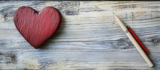 Wooden heart and love notes on rustic table background romantic concept with selective focus on heart and writing tools