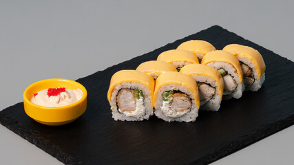 Sushi rolls on black tray