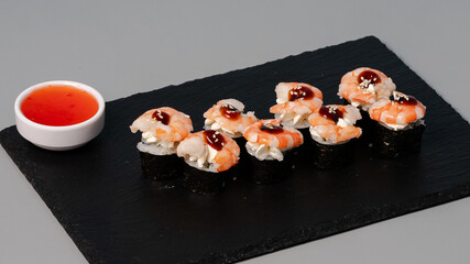 Sushi rolls on black tray