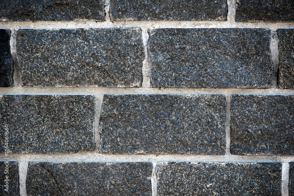 Fototapete wall of stones. brick wall. gray background with black geometric patterns, of rectangular stones, br