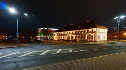 Fototapeta premium View of the night city. The central square of the city at night without people. Burning lanterns and city lighting.
