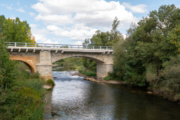 Fototapeta premium Bridge over the Porma River in the town of Puente Villarente de Villaturiel on the Camino de Santiago in the Province of Leon