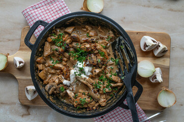 Zürcher geschnetzeltes with turkey breast in a  delicious mushroom sauce with  roasted onions and sour cream in a pan