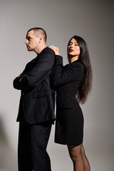 A beautiful young couple poses together in stylish outfits, showcasing their romance.