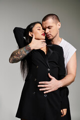 A young couple embraces passionately in a chic studio, capturing Valentines Day romance.