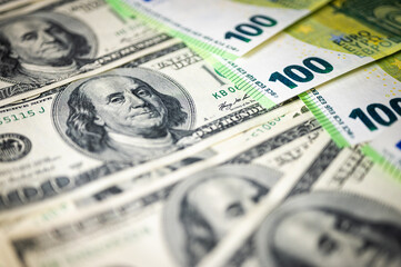 100 dollar bills and 100 euro bills close-up symbolize wealth, international finance, currency exchange and world economy, world currency market, competitors