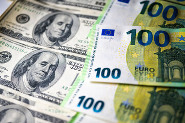 100 dollar bills and 100 euro bills close-up symbolize wealth, international finance, currency exchange and world economy, world currency market, competitors