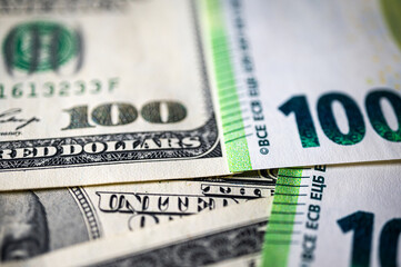 100 dollar bills and 100 euro bills close-up symbolize wealth, international finance, currency exchange and world economy, world currency market, competitors