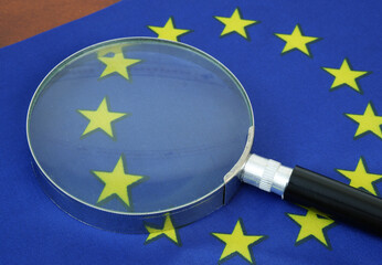 Magnifying glass on European Union flag.	