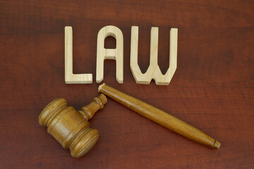 Broken judge gavel and letters LAW. Lawlessness concept.