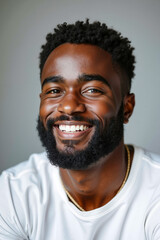 A man with a beard smiles at the camera