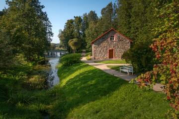 A traditional stone barn for storing flax on the shore of the pond 