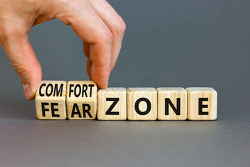 Comfort or fear zone symbol. Concept words Comfort zone Fear zone on wooden cubes. Beautiful grey table grey background. Psychologist hand. Business and comfort or fear zone concept. Copy space.