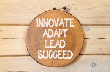 Innovate adapt lead succeed symbol. Concept words Innovate Adapt Lead Succeed on beautiful wooden circle. Beautiful wooden wall background. Business innovate adapt lead succeed concept. Copy space.