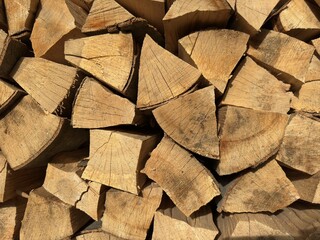 Firewood background. Firewood stack. Stacked split logs. Woodpile. Firewood for winter.