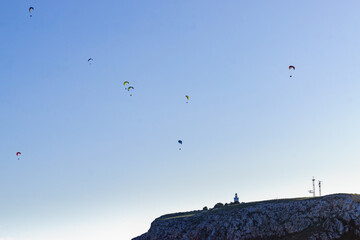 Paragliders flying in sky.