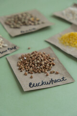 Raw buckwheat porridge with text in paper. Refill product format eco-friendly living. Filling reusable container Whole spelt grain species. High protein fiber-rich vegan plant based food ingredient