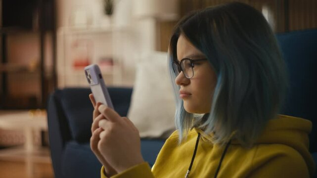 Teen girl cries after reading hurtful comments on her phone, feeling overwhelmed