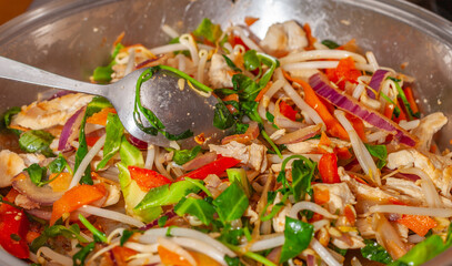 Chicken stir fry with spoon in a pan