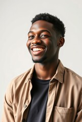 Obraz premium Smiling Young Man in Casual Attire with Neutral Background