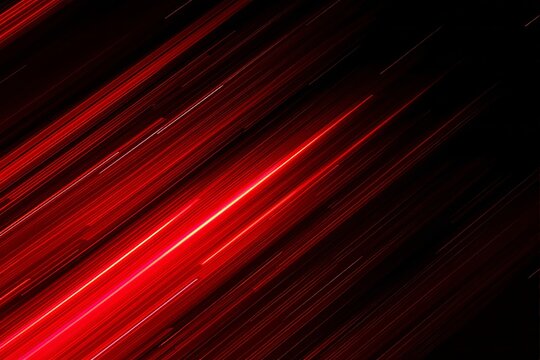 Abstract red light streaks diagonally over black background.