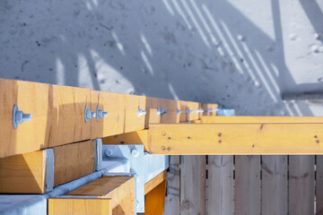 
A joint of wooden beams, most likely part of a structure such as a house or terrace, where the...