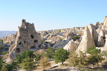 Rock formations with caves on a sunny day in Cappadocia, Anatolia,  eastern Turkey