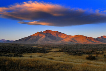 Sunset or Sunrise on Mountain with Cloud in Sky