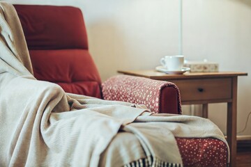 Cozy armchair with a knitted throw