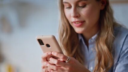 Housewife hands messaging cellphone in kitchen domestic weekend morning closeup