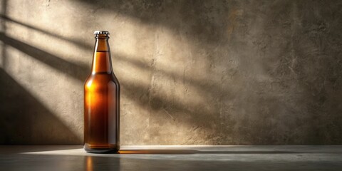 A single amber glass bottle of beverage sits on a flat surface against a textured wall, illuminated by sunlight streaming through a window.