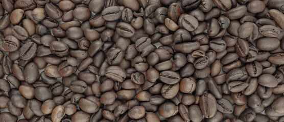 Roasted coffee beans, rich brown color, close-up view. Perfect for coffee packaging, websites, or any project needing a coffee theme.