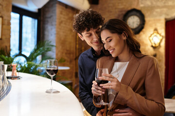 Young couple enjoys a special moment together, celebrating love in a cozy restaurant.