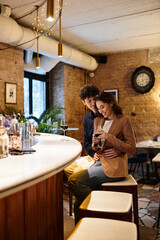A lovely young couple enjoys an intimate celebration at a restaurant on Valentines Day.