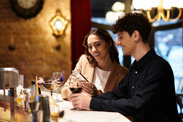 A lovely couple enjoys drinks and smiles while celebrating their special day at a restaurant.