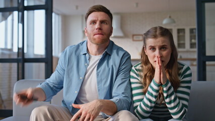 Nervous fans watching football at home closeup. Tensed woman man rejoicing win