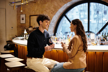 A young couple enjoys a romantic moment together in a chic restaurant.